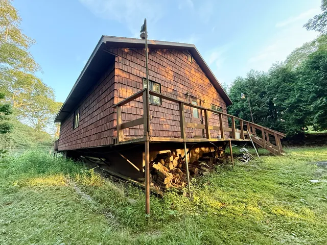 a backyard of a house with wooden floor and fence