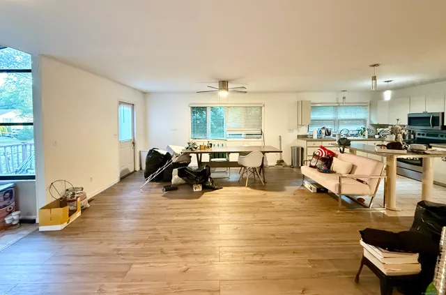 a living room with furniture and a wooden floor