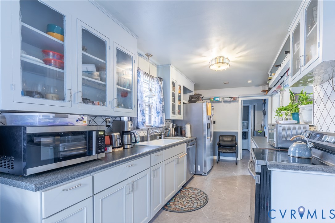 423 Atwater Road Hopewell, VA 23860 - Photo 6 of 14 a kitchen with stainless steel appliances kitchen island granite countertop a sink and cabinets