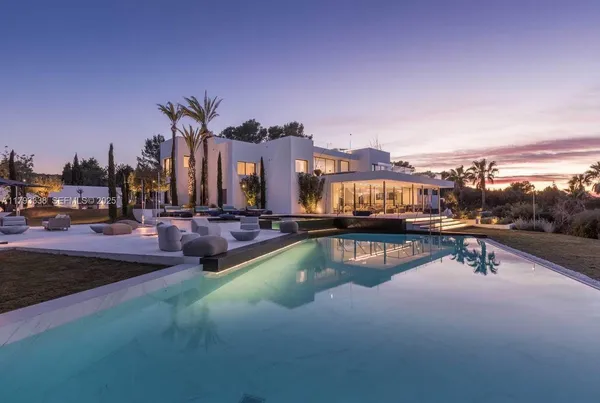 a view of a swimming pool with a table and chairs