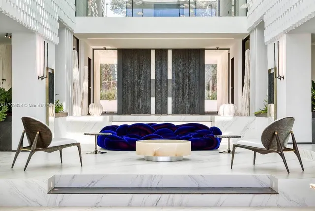 a kitchen with stainless steel appliances a table chairs and a wooden floor