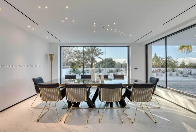 a view of a hallway with wooden chairs