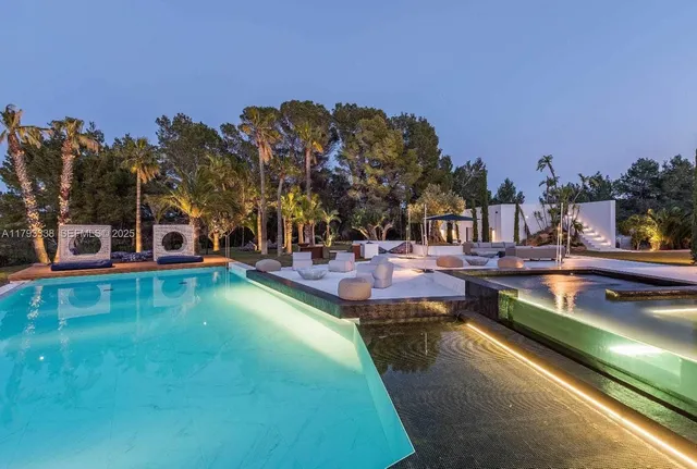 a view of a swimming pool with outdoor seating