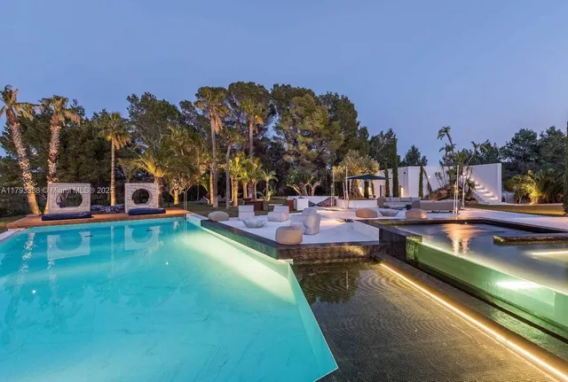 a view of a swimming pool with outdoor seating