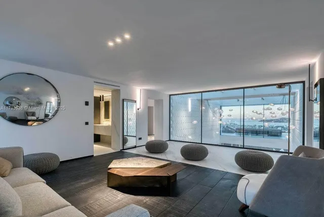 a room with stainless steel appliances kitchen island a refrigerator and a counter top