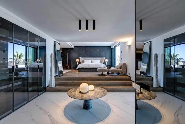 a bedroom with a bed and a large window