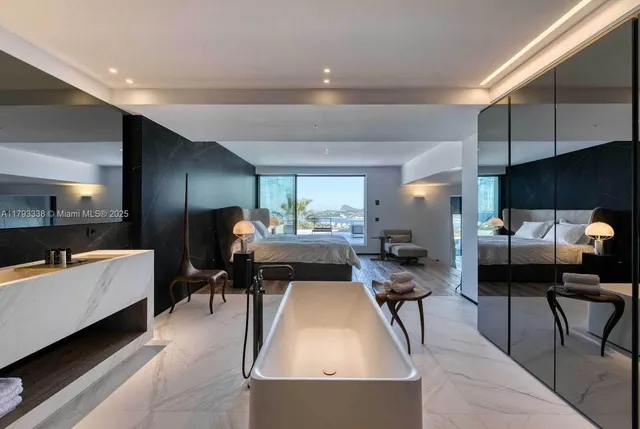 a large bathroom with a large tub and sink