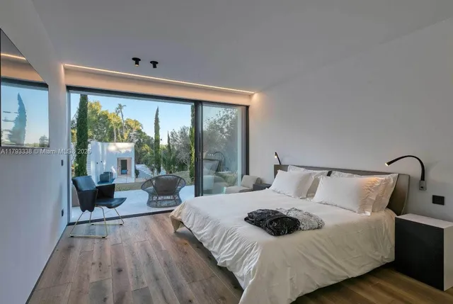 a spacious bathroom with a double vanity sink a large mirror and a bathtub