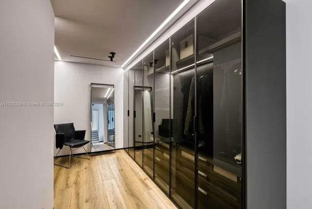 a bedroom with a bed and a large mirror