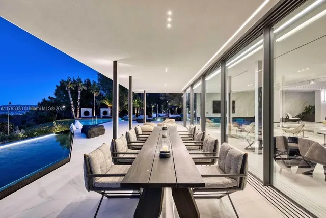 a living room with stainless steel appliances kitchen island granite countertop furniture a rug and a window