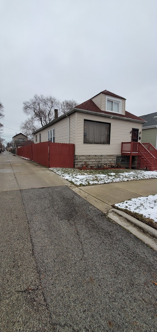 9315 South Clyde Avenue Chicago, IL 60617 - Photo 2 of 32 a view of a house with a snow on the road