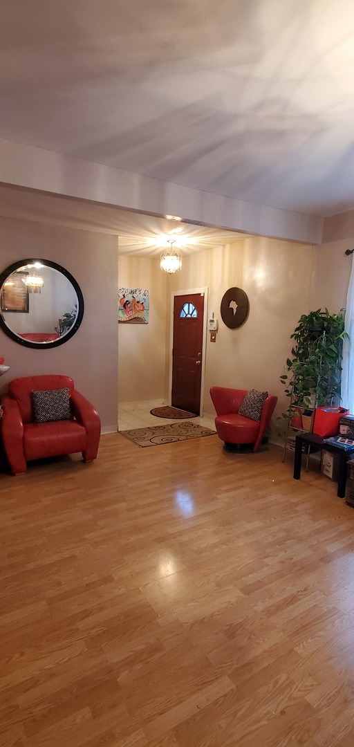 9315 South Clyde Avenue Chicago, IL 60617 - Photo 4 of 32 a view of a room with furniture and a garage