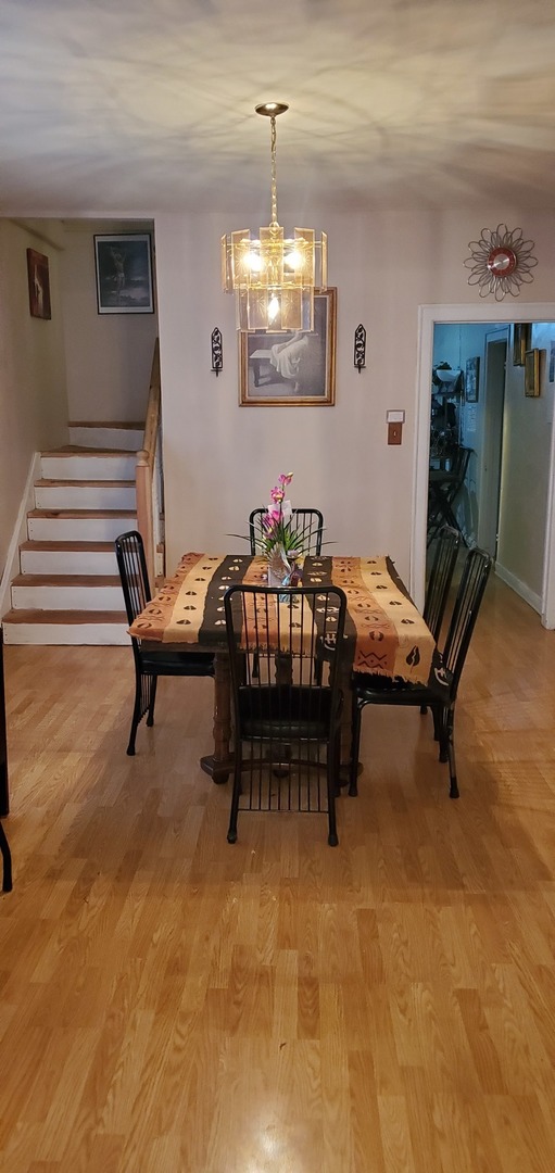 9315 South Clyde Avenue Chicago, IL 60617 - Photo 7 of 32 a living room with furniture and a chandelier