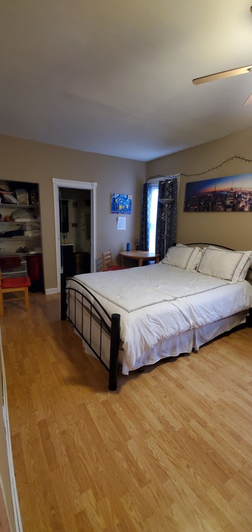 9315 South Clyde Avenue Chicago, IL 60617 - Photo 8 of 32 a bedroom with a bed and a television in it