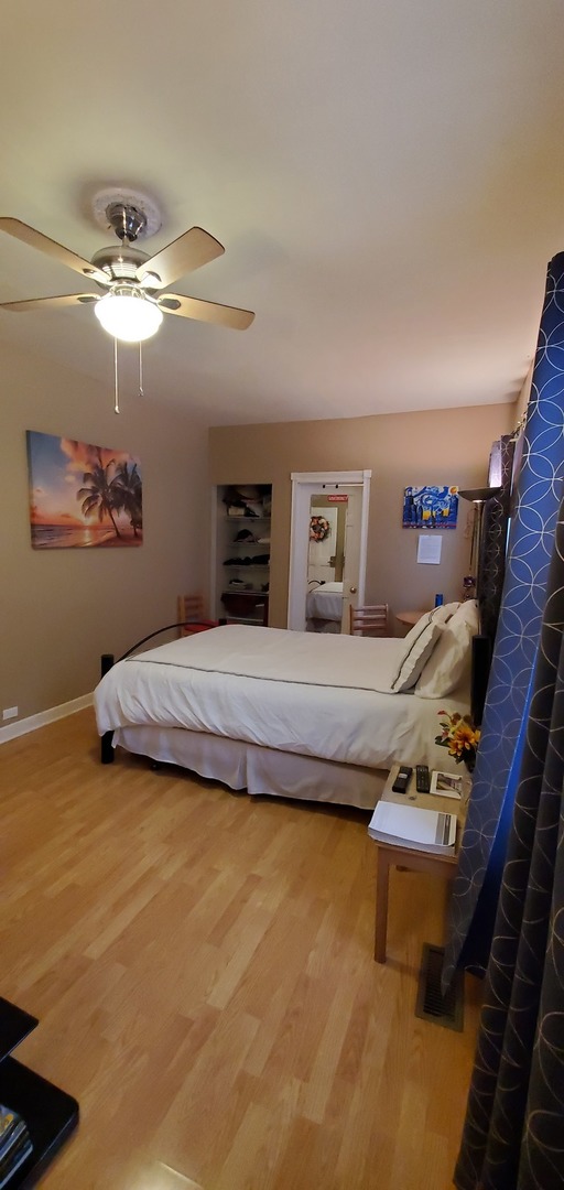 9315 South Clyde Avenue Chicago, IL 60617 - Photo 10 of 32 a bedroom with a bed and ceiling fan