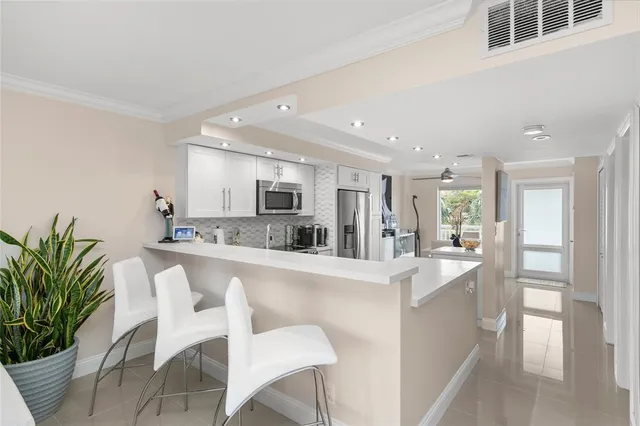 a dining room with furniture and a chandelier