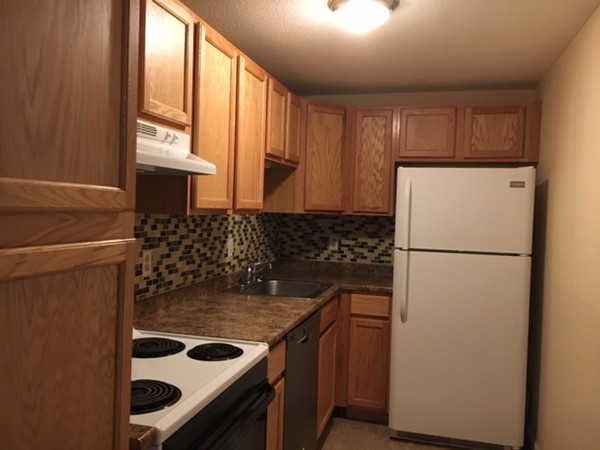 80 Leonard Road, Unit 80 Boxborough, MA 01719 - Photo 2 of 6 a kitchen with a stove and a refrigerator