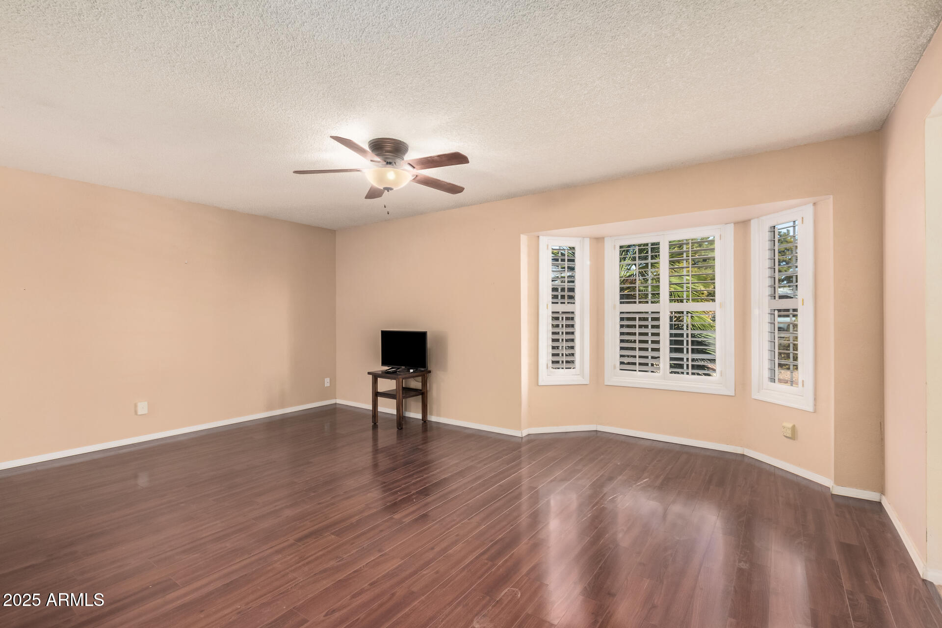 4321 West Greenway Road Glendale, AZ 85306 - Photo 17 of 39 a view of an empty room with a window and wooden floor