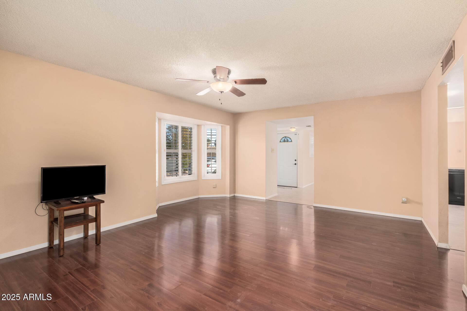 4321 West Greenway Road Glendale, AZ 85306 - Photo 18 of 39 a view of an empty room with wooden floor and a window