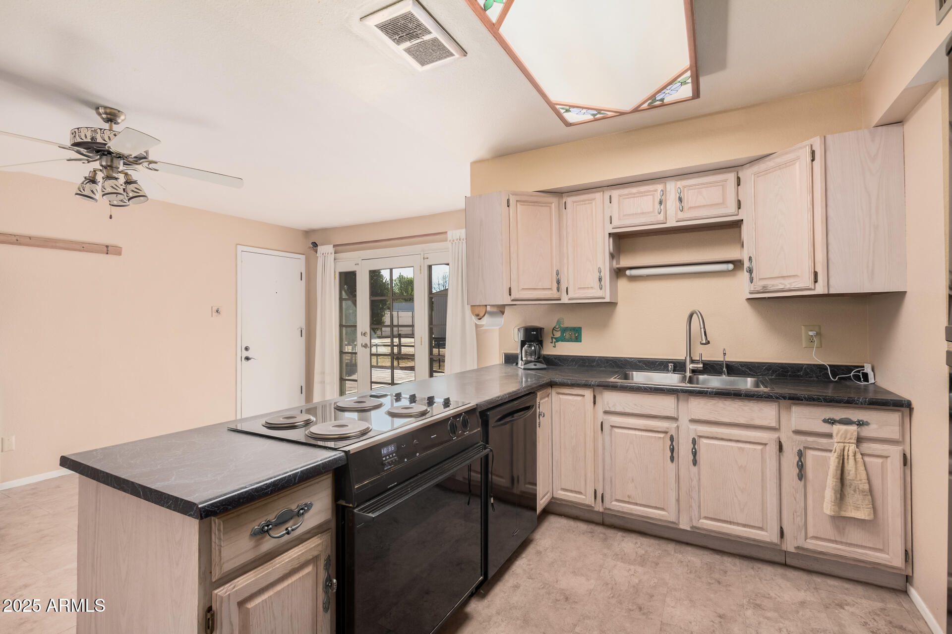 4321 West Greenway Road Glendale, AZ 85306 - Photo 24 of 39 a kitchen with granite countertop a sink and cabinets