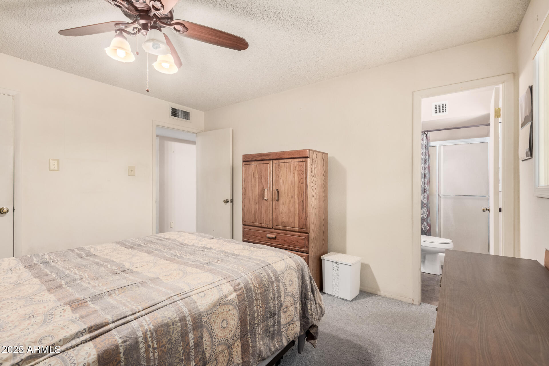 4321 West Greenway Road Glendale, AZ 85306 - Photo 27 of 39 a bedroom with a bed and a chandelier