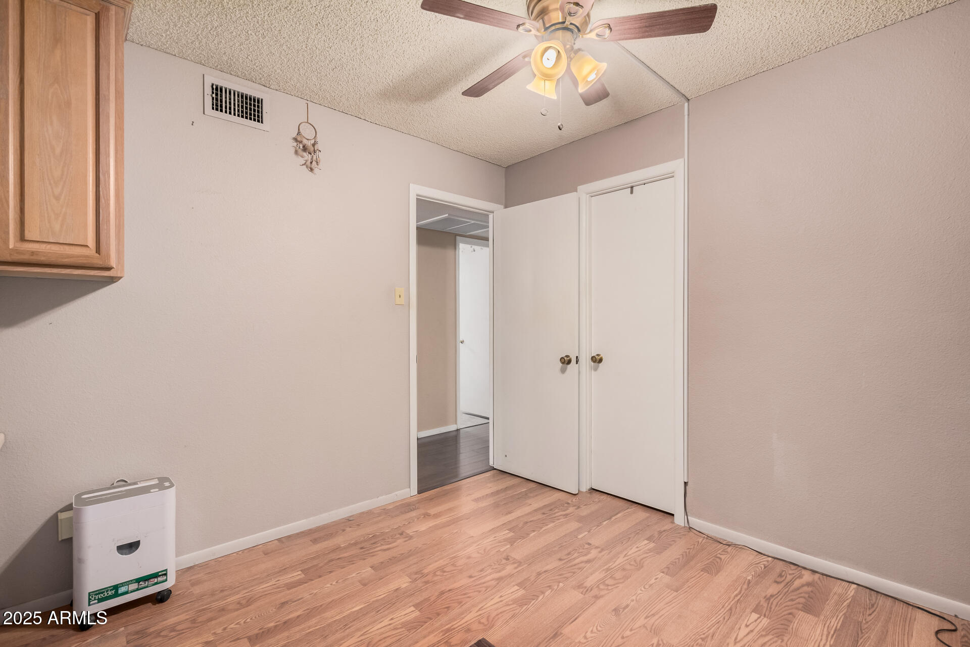 4321 West Greenway Road Glendale, AZ 85306 - Photo 34 of 39 an empty room with a window and a ceiling fan