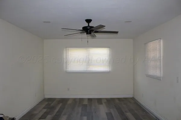 a room with a window and a ceiling fan