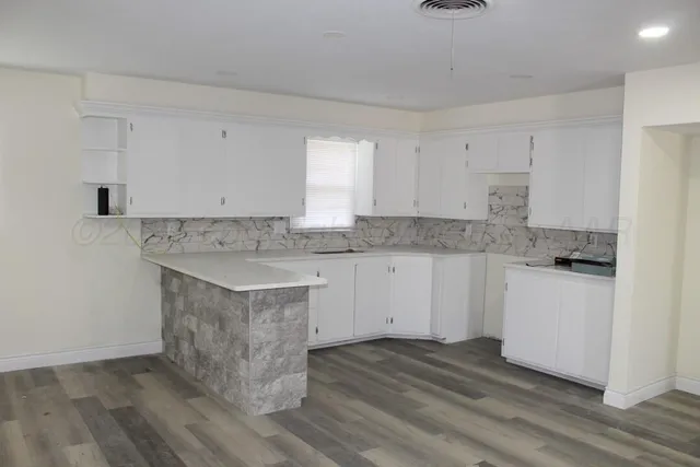 a view of a kitchen with granite countertop white cabinets and white appliances