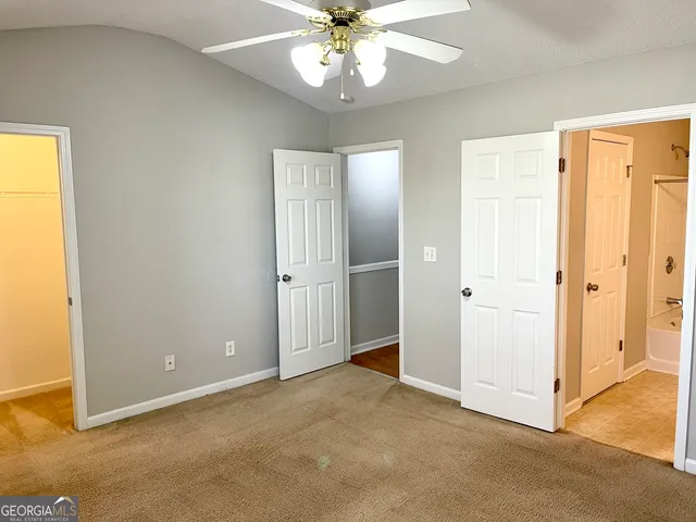 a view of an empty room with a ceiling fan