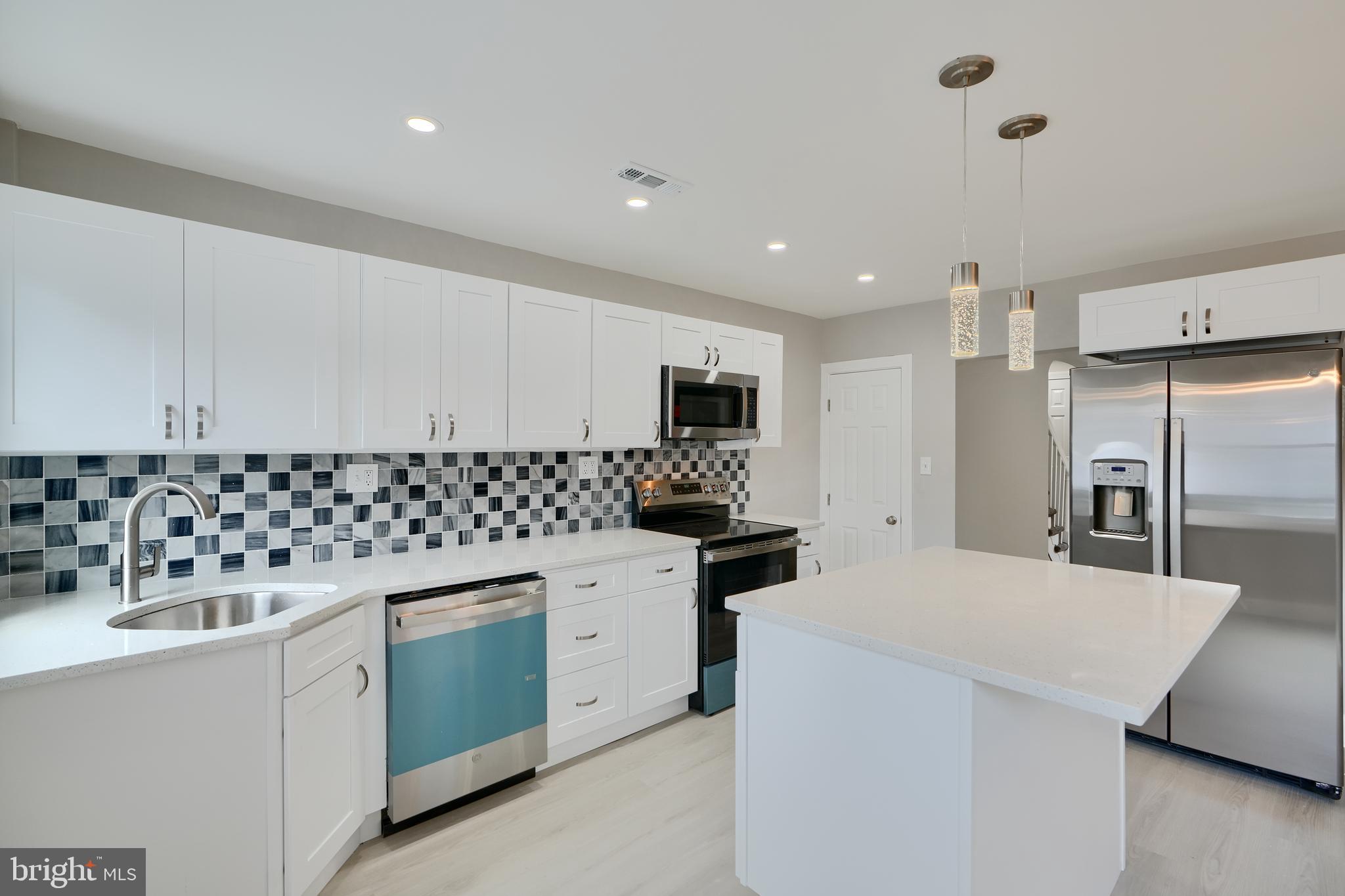 4239 Rokeby Road Baltimore, MD 21229 - Photo 1 of 22 a kitchen with granite countertop a sink stainless steel appliances and white cabinets