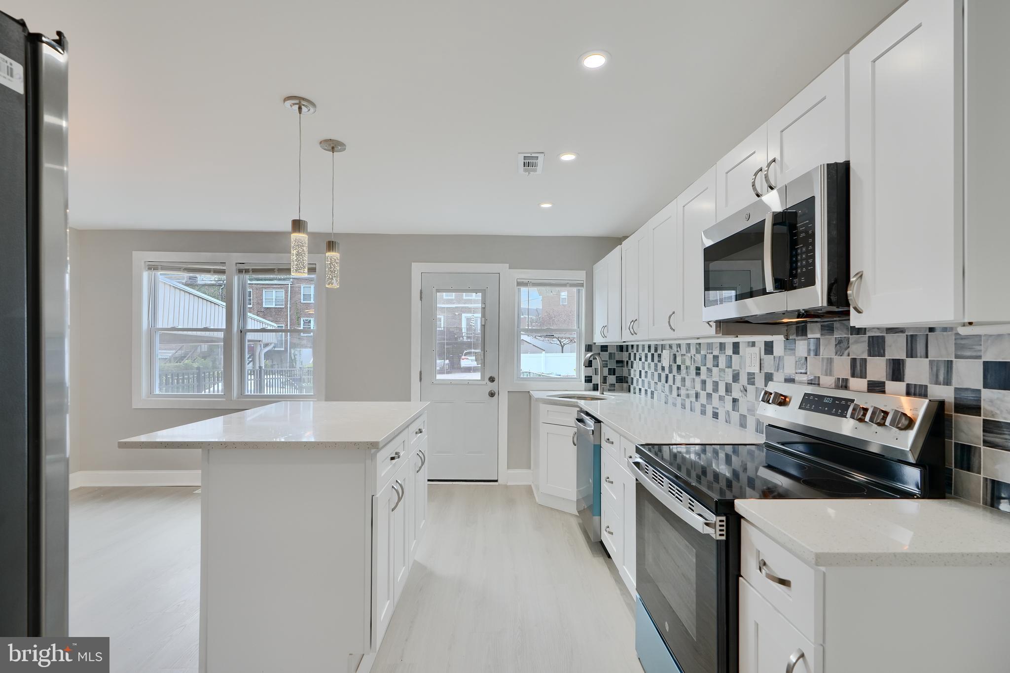 4239 Rokeby Road Baltimore, MD 21229 - Photo 6 of 22 a kitchen with stainless steel appliances a sink stove and cabinets