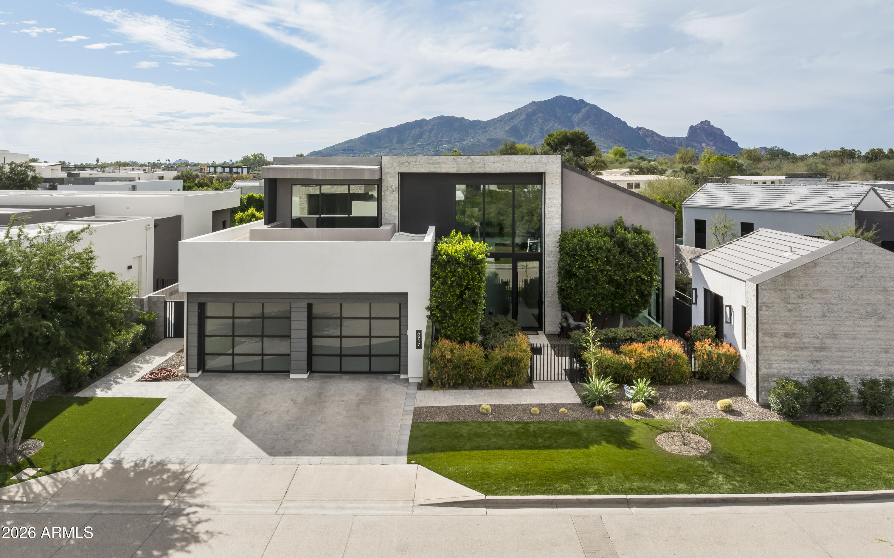 6917 East Cactus Wren Road Paradise Valley, AZ 85253 - Photo 3 of 39 a view of house with a yard and potted plants