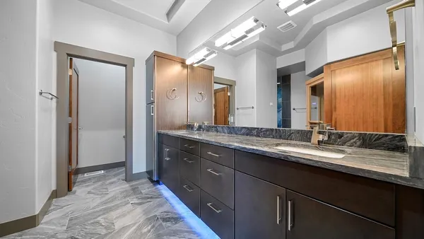 a bathroom with a double vanity sink and a mirror