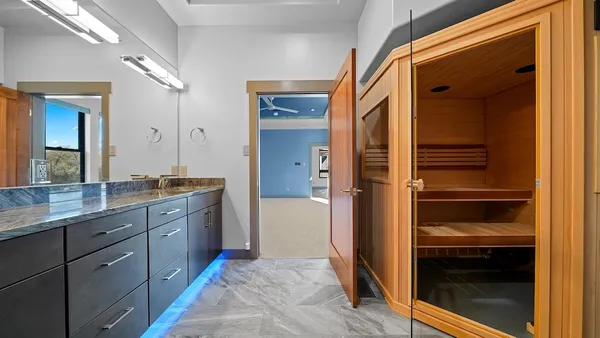 a bathroom with a granite countertop sink and mirror