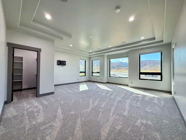 an empty room with windows and closet