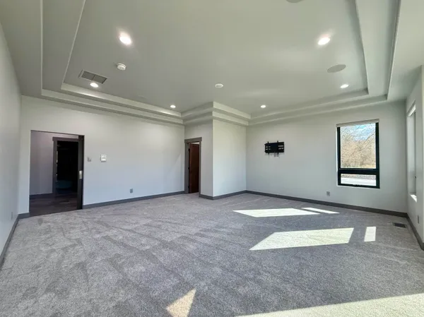 an empty room with windows and entrance