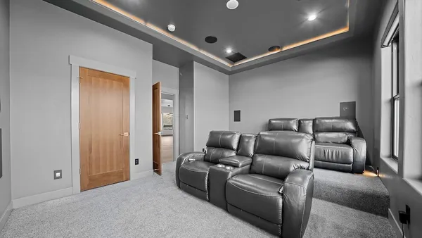 an empty room with cabinet and windows