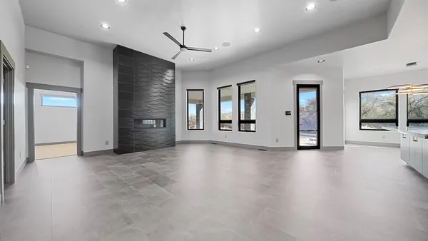 an empty room with window and wooden floor