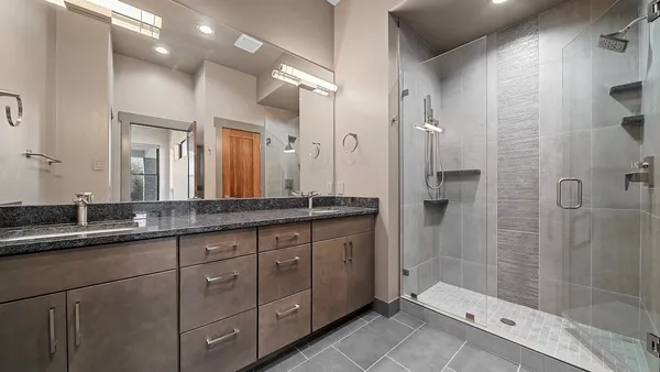 a bathroom with a granite countertop sink mirror and double