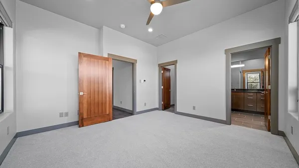 a view of empty room with cabinet and ceiling fan