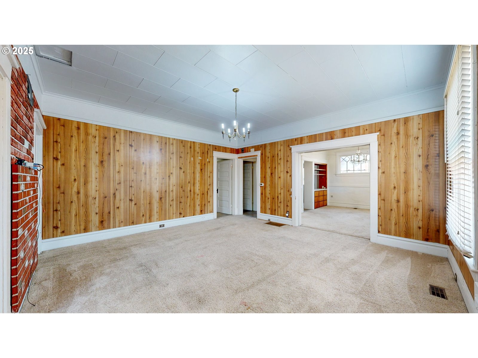 2438 Auburn Avenue Baker City, OR 97814 - Photo 13 of 41 a living room with a large window and chandelier