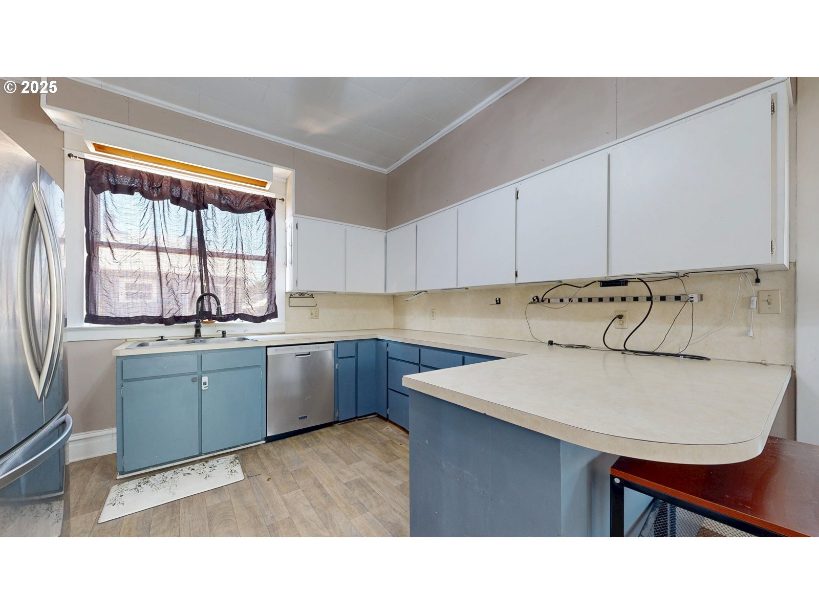 2438 Auburn Avenue Baker City, OR 97814 - Photo 17 of 41 a kitchen with a sink a stove a window cabinets and a dining table