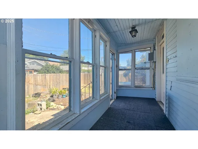 a black and white house with a yard