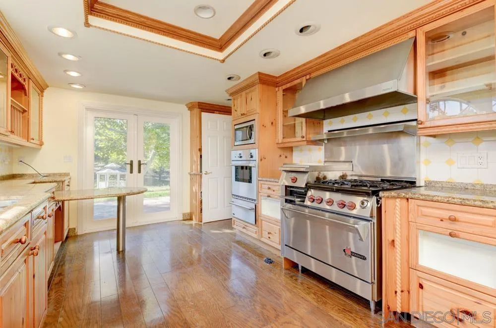 4735 Olive Hill Road Fallbrook, CA 92028 - Photo 16 of 22 a kitchen with a stove and a refrigerator