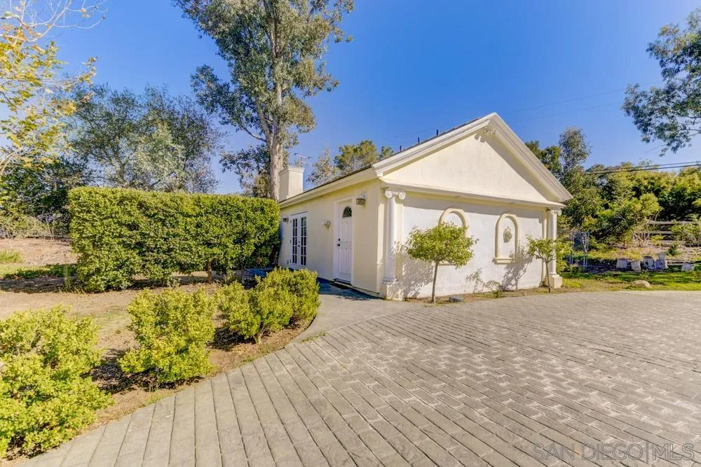 4735 Olive Hill Road Fallbrook, CA 92028 - Photo 18 of 22 a front view of a house with a yard and garage