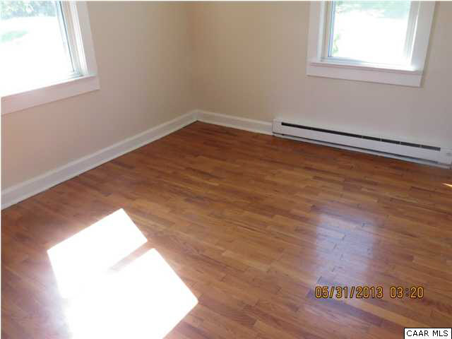 1535 Simms Road Stanardsville, VA 22973 - Photo 4 of 12 an empty room with wooden floor and windows