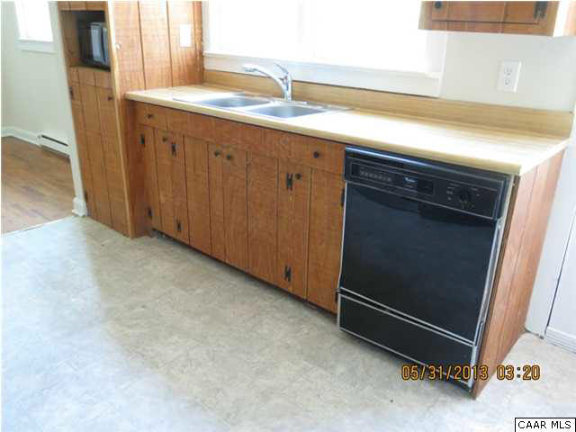 1535 Simms Road Stanardsville, VA 22973 - Photo 6 of 12 a kitchen with granite countertop cabinets and white appliances
