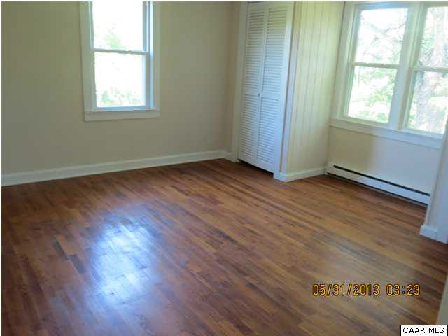 1535 Simms Road Stanardsville, VA 22973 - Photo 9 of 12 an empty room with wooden floor and windows