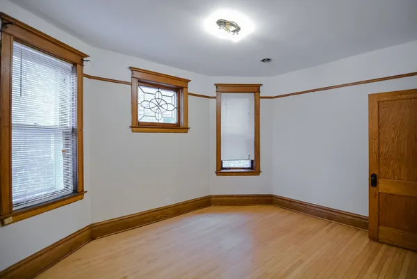 a view of a room with wooden floor and window