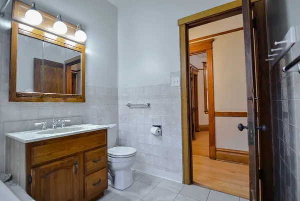 a bathroom with a toilet sink shower and mirror